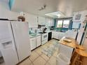 Bright and airy kitchen with white cabinets and ocean view at 6009 Sea Ranch Dr # 301, Hudson, FL 34667