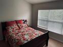 Bright bedroom with a double window dressed with a floral comforter at 10453 Westpark Preserve Blvd, Tampa, FL 33625