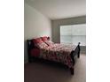 Bright bedroom with a double window dressed with a floral comforter at 10453 Westpark Preserve Blvd, Tampa, FL 33625