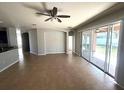 Spacious living room with tile floors and sliding glass doors leading to the backyard at 8818 Deep Maple Dr, Riverview, FL 33578