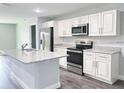 Modern kitchen with white cabinets and granite countertops at 13435 Kaplan Ter, Port Charlotte, FL 33981