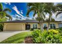 House with two-car garage and lush landscaping at 39 Tee View Pl, Rotonda West, FL 33947