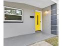 Inviting entryway with a bright yellow door and modern design at 304 W Fern St, Tampa, FL 33604