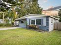 Renovated ranch home, gray and yellow, with a landscaped yard at 304 W Fern St, Tampa, FL 33604