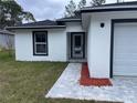 Front entrance of a newly built home at 17207 Waldrun Ave, Port Charlotte, FL 33948