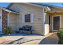 House entrance with a bench and a small patio area at 5846 Greenbriar Ct, Zephyrhills, FL 33542