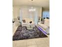 Spacious living room with white leather furniture and a large rug at 6327 Yellow Buckeye Dr # 6327, Riverview, FL 33578