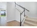 Bright entryway features a carpeted staircase with white railings and modern black accents at 5936 Jensen View Ave, Apollo Beach, FL 33572