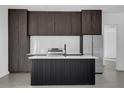 Contemporary kitchen featuring dark wood cabinets, stainless steel appliances, and an island at 501 Chastain Rd, Seffner, FL 33584