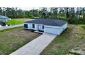 New construction home with gray roof and paver driveway at 5161 Churchill Rd, Port Charlotte, FL 33981