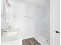 Clean bathroom with double vanity, marble shower, and updated fixtures at 22112 Mamaroneck Ave, Port Charlotte, FL 33952