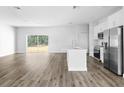 Open living space with wood-look floors and an open kitchen concept at 22112 Mamaroneck Ave, Port Charlotte, FL 33952