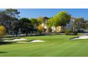 Scenic view of a lush green golf course with sand bunkers and a distant building at 407 Belvedere Oval, Temple Terrace, FL 33617