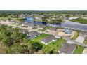 Aerial view of new home construction and community with water features and greenery at 9071 Players Dr, Weeki Wachee, FL 34613