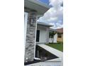 Close-up of a home's front entrance with stone accents and manicured landscaping at 183 Wright Drive, Rotonda West, FL 33947