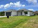 A well-maintained single-story home with a lush lawn and an inviting front entrance at 183 Wright Drive, Rotonda West, FL 33947