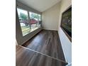 Sunroom with new wood laminate flooring, with access to front yard views at 7403 Foxbloom Dr, Port Richey, FL 34668