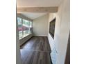 Sunroom with new wood laminate flooring, accented by a colorful stained-glass mosaic at 7403 Foxbloom Dr, Port Richey, FL 34668
