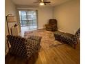 Cozy living room featuring armchairs, a recliner, area rug and natural light at 215 Valencia Blvd # 212, Belleair Bluffs, FL 33770