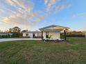 Inviting single-story home featuring fresh white paint, black accents, and green yard at 460 Creek Lane Dr, Englewood, FL 34223