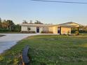 Charming single-story home with carport, fresh paint, modern accents, and a spacious yard at 460 Creek Lane Dr, Englewood, FL 34223