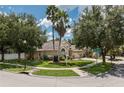 Well maintained single-Gathering home with a manicured lawn and mature trees in a suburban neighborhood at 7139 Colony Pointe Dr, Riverview, FL 33578