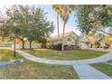 Inviting single-Gathering home with lush green lawn and mature trees, providing shade and curb appeal at 7139 Colony Pointe Dr, Riverview, FL 33578