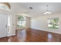 Bright living room with hardwood floors, large windows, and a high ceiling for a spacious feel at 7139 Colony Pointe Dr, Riverview, FL 33578