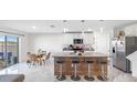 Stylish kitchen with an island, bar stools, stainless steel appliances, and easy access to the outdoor patio via sliding doors at 7522 Rosewood Garden Loop, Tampa, FL 33637