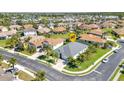 Aerial view of the lovely home nestled in a vibrant neighborhood with lush landscaping and mature trees at 2640 Suncoast Lakes Blvd, Punta Gorda, FL 33980