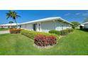 Low angle view of a bright home featuring neatly trimmed landscaping in a tranquil residential neighborhood at 6522 11Th W Ave, Bradenton, FL 34209