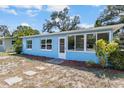 Cozy one-story blue house with bright windows and a neatly landscaped front yard at 1724 Harbor Dr, Clearwater, FL 33755