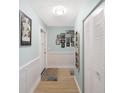 Light and bright hallway leading into the unit featuring ample closet space at 5501 80Th N St # 201, St Petersburg, FL 33709