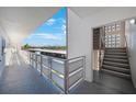 Hallway featuring an exterior view of assigned parking and leading to a stairwell at 5501 80Th N St # 201, St Petersburg, FL 33709