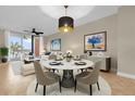 Elegant dining area with modern decor and ample natural light at 606 Riviera Dunes Way # 207, Palmetto, FL 34221