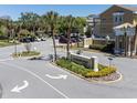 Community entrance featuring decorative signage, landscaping, and multiple parking spots at 2210 Utopian E Dr # 314, Clearwater, FL 33763