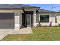 A charming single-Gathering home with a well-kept lawn, attractive landscaping and an attached garage at 2723 Jollivette Rd, North Port, FL 34288