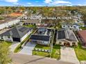 Aerial view of a well-maintained property with solar panels, carport, and landscaped yard at 2912 W Frierson W Ave, Tampa, FL 33614