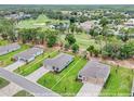 Aerial shot showing the property's boundaries, landscaping, and location within the neighborhood at 9143 Players Dr, Weeki Wachee, FL 34613
