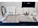 Collection of interior design material samples showcasing flooring, cabinet, and countertop options at 9176 Players Dr, Weeki Wachee, FL 34613
