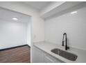 Modern kitchen features a stainless steel sink with a black faucet and white subway tile backsplash at 2353 Shelley St # 10, Clearwater, FL 33765