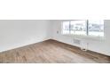 Living area showcasing hard surface floors, freshly painted white walls and bright window at 2353 Shelley St # 18, Clearwater, FL 33765