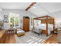 Bright main bedroom with a vaulted ceiling, wood beam, and plantation shutters at 1025 Royal Troon Ct, Tarpon Springs, FL 34688