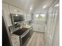 Modern kitchen features stainless steel appliances, granite countertops, and ample cabinet space at 6009 Sea Ranch Dr # 101, Hudson, FL 34667