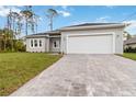 Charming single-story home with a two-car garage, landscaped yard and brick paver driveway at 4160 Belladonna Ave, North Port, FL 34286