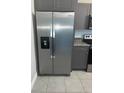 Stainless steel refrigerator with water dispenser and grey cabinets at 15008 Spokane Rd, Spring Hill, FL 34610