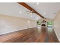 Spacious living room boasts vaulted ceilings, hardwood floors, and a stunning stone fireplace at 6005 Ike Smith Rd, Plant City, FL 33565