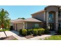 Exterior view of home with well maintained landscaping and a three-car garage at 16219 Turnbury Oak Dr, Odessa, FL 33556