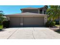 Three car garage with house number over garage doors at 16219 Turnbury Oak Dr, Odessa, FL 33556