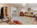 Inviting living room with cozy seating, neutral tones, ceiling fan and sliding door access to patio at 219 S Mcmullen Booth Rd # 175, Clearwater, FL 33759